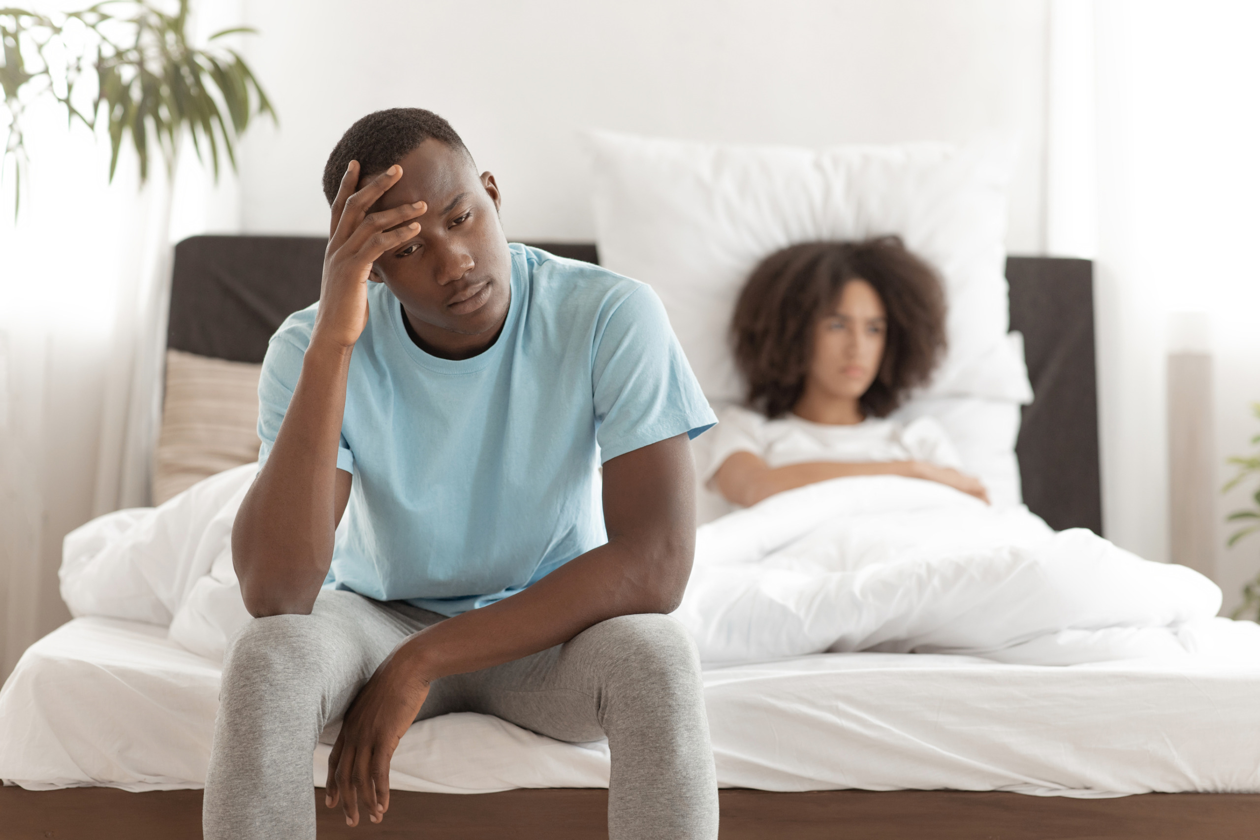 Unhappy couple in bed